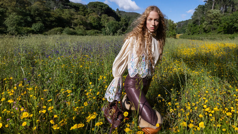 Model Raquel Zimmerman in a green field for Winter 26 campaign